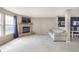 Comfortable living room with stone fireplace, large windows, and a stylish sofa for relaxing gatherings at 8709 Orchard Grove Ln, Camby, IN 46113