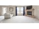 Bright living room with stone fireplace and comfortable seating, offering a relaxing space for entertaining at 8709 Orchard Grove Ln, Camby, IN 46113
