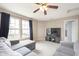 Living room featuring a large sectional sofa, a ceiling fan, and large windows at 8709 Orchard Grove Ln, Camby, IN 46113
