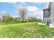 Expansive backyard featuring a lush lawn and a patio area, perfect for outdoor entertaining at 8811 Dorill Creek Ln, Indianapolis, IN 46259