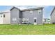 Large backyard with a patio seating area, a lush lawn, and a partial fence at 8811 Dorill Creek Ln, Indianapolis, IN 46259