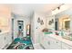 Modern bathroom with double vanity, ample storage and decorative accents throughout at 8811 Dorill Creek Ln, Indianapolis, IN 46259