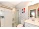 Bathroom featuring a walk-in shower, a modern vanity with storage, and bright lighting at 8811 Dorill Creek Ln, Indianapolis, IN 46259