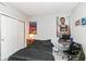 Bedroom with a gray walls features a large bed, closet and sports memorabilia wall decor at 8811 Dorill Creek Ln, Indianapolis, IN 46259