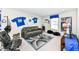 Bonus room features a large couch, decorative sports-themed decor and comfortable furnishings at 8811 Dorill Creek Ln, Indianapolis, IN 46259