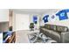 Bonus room features a large couch, decorative sports-themed decor and comfortable furnishings at 8811 Dorill Creek Ln, Indianapolis, IN 46259