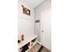 Mudroom features a built-in bench with storage, a KEYS sign and modern wall decor at 8811 Dorill Creek Ln, Indianapolis, IN 46259
