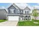 Beautiful two-story home with blue and gray siding, stone accents, and a well-manicured lawn at 8811 Dorill Creek Ln, Indianapolis, IN 46259