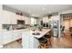 Modern kitchen featuring white cabinetry, stainless steel appliances, and a center island with seating at 8811 Dorill Creek Ln, Indianapolis, IN 46259