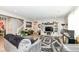 Bright and airy living room with hardwood floors, a staircase, and a modern entertainment center at 8811 Dorill Creek Ln, Indianapolis, IN 46259