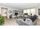 Spacious living room with hardwood floors, a gray sectional sofa, and a large window at 8811 Dorill Creek Ln, Indianapolis, IN 46259