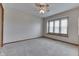 Bright bedroom featuring neutral carpet, ceiling fan, and natural light from the window at 948 Peppermill Run, Greenwood, IN 46143