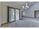 Bright dining room featuring slider doors to sunroom and neutral carpeting at 948 Peppermill Run, Greenwood, IN 46143
