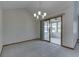Bright dining room features slider doors to sunroom and modern chandelier at 948 Peppermill Run, Greenwood, IN 46143