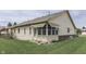 Back exterior view of house with awning covered windows and a well-maintained lawn at 948 Peppermill Run, Greenwood, IN 46143