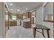 Bright kitchen featuring wood cabinets, white appliances, tile floors, and a convenient breakfast nook area at 948 Peppermill Run, Greenwood, IN 46143