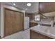 Kitchen with wooden cabinets, white countertops, tile floor, and a closet with access to laundry appliances at 948 Peppermill Run, Greenwood, IN 46143