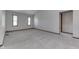 Comfortable living room with neutral carpet, light walls, and ample natural light from two windows at 948 Peppermill Run, Greenwood, IN 46143