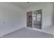 Cozy sunroom with white horizontal paneling and slider door to dining room at 948 Peppermill Run, Greenwood, IN 46143