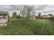 Large backyard featuring a storage shed, mature trees, and a wood privacy fence at 1015 Supernova Dr, Franklin, IN 46131