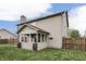 Spacious backyard featuring a covered patio, well-maintained lawn, and a wooden fence at 1015 Supernova Dr, Franklin, IN 46131
