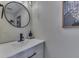Stylish bathroom vanity featuring a round mirror, sleek black faucet, and modern lighting at 1015 Supernova Dr, Franklin, IN 46131