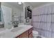 This bathroom features a wood vanity, large mirror, and shower/tub combo with a decorative shower curtain at 1015 Supernova Dr, Franklin, IN 46131