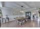 Spacious dining room featuring a long wood table with metal chairs, wainscoting and a stylish light fixture at 1015 Supernova Dr, Franklin, IN 46131