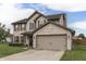 Charming two-story home featuring a brick and siding exterior with a two-car garage at 1015 Supernova Dr, Franklin, IN 46131