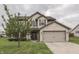 Charming two-story home with brick and siding facade, well-manicured lawn, and attached two-car garage at 1015 Supernova Dr, Franklin, IN 46131