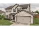 Charming two-story home featuring a brick and siding exterior with a two-car garage at 1015 Supernova Dr, Franklin, IN 46131