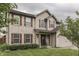 Charming two-story home with brick and siding, shutters, manicured lawn and inviting front porch at 1015 Supernova Dr, Franklin, IN 46131