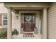 Inviting front porch with decorative wreath, welcome sign, pillars, and stylish decor at 1015 Supernova Dr, Franklin, IN 46131