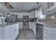 Modern kitchen featuring white cabinets, mosaic backsplash, stainless steel appliances, and functional layout at 1015 Supernova Dr, Franklin, IN 46131