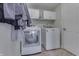 Well-equipped laundry room with modern washer, dryer, and ample white cabinet storage at 1015 Supernova Dr, Franklin, IN 46131