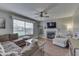 Cozy living room with hardwood flooring, fireplace, ceiling fan, and comfortable seating at 1015 Supernova Dr, Franklin, IN 46131