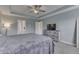 Bright main bedroom showcasing a trey ceiling, carpet, and modern decor at 1015 Supernova Dr, Franklin, IN 46131