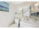 Compact bathroom featuring a white vanity, stylish lighting, and modern decor at 1030 Stratford Hall # 17-3, Indianapolis, IN 46260