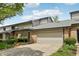 Charming townhome featuring a brick facade, attached garage, and lovely landscaping at 1030 Stratford Hall # 17-3, Indianapolis, IN 46260