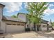 Charming home exterior with a two-car garage, mature tree, and well-maintained yard at 1030 Stratford Hall # 17-3, Indianapolis, IN 46260