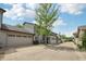 Charming home exterior with a two-car garage, mature tree, and well-maintained yard at 1030 Stratford Hall # 17-3, Indianapolis, IN 46260