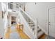 Bright foyer with wood floors and staircase at 1030 Stratford Hall # 17-3, Indianapolis, IN 46260