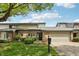 Charming townhome featuring a brick facade, attached garage, and well-manicured lawn at 1030 Stratford Hall # 17-3, Indianapolis, IN 46260