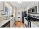 Bright kitchen with stainless steel appliances and granite counters at 1030 Stratford Hall # 17-3, Indianapolis, IN 46260