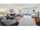 Spacious living room featuring neutral carpet, comfortable seating, and large windows at 1030 Stratford Hall # 17-3, Indianapolis, IN 46260
