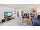Bright living room with blue couches, wood accents, and ample natural light at 1030 Stratford Hall # 17-3, Indianapolis, IN 46260
