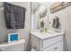 Clean bathroom features a white vanity with a quartz countertop, and gray-themed decor at 10358 Pronghorn Ln, Indianapolis, IN 46239