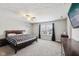 Spacious bedroom featuring a king-size bed, ceiling fan, and a bright window with black-out curtains at 10358 Pronghorn Ln, Indianapolis, IN 46239