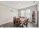 Cozy dining area features a floral tablecloth, window with natural light, and storage bookcase at 10358 Pronghorn Ln, Indianapolis, IN 46239