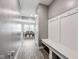 Welcoming entryway with gray walls, wood floors and a convenient mudroom bench with coat hooks at 10358 Pronghorn Ln, Indianapolis, IN 46239